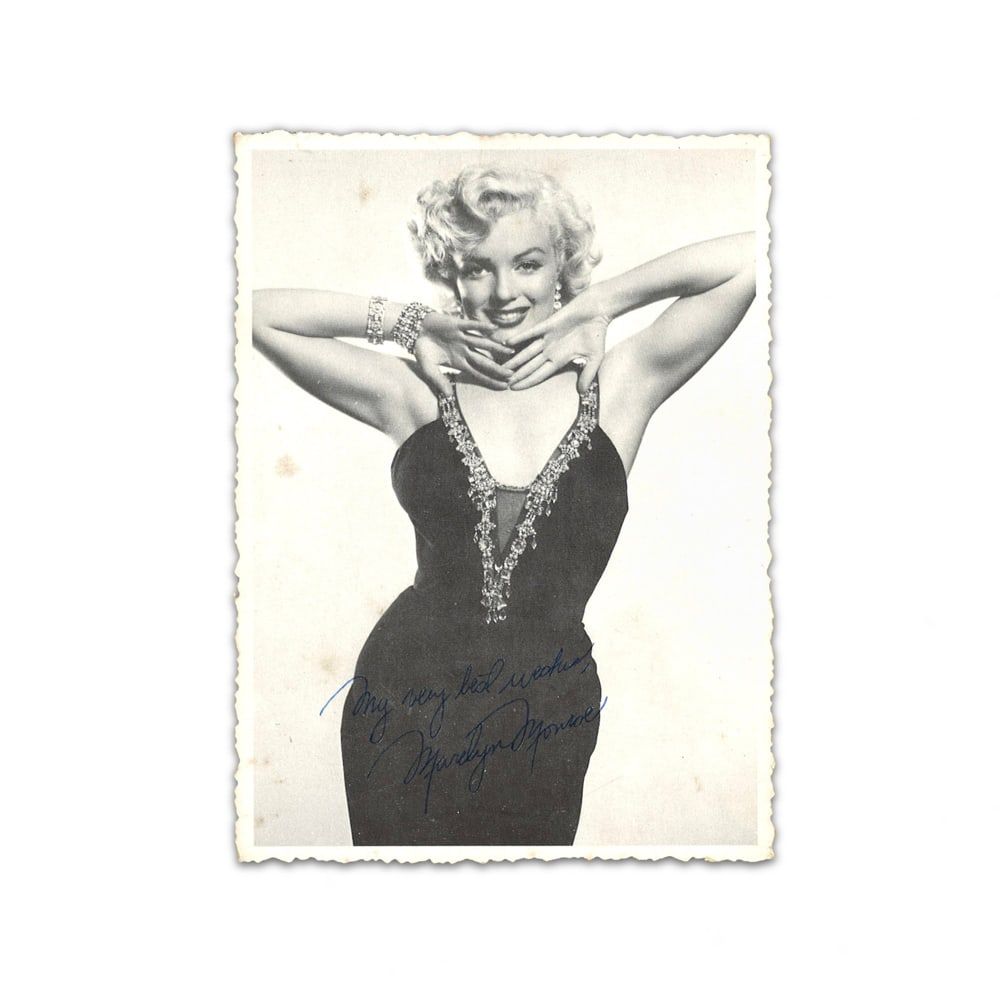 MARILYN MONROE SIGNED SILVER GELATIN PHOTOGRAPH: 6 1/8 x 4 1/8 in (15.5 x 10.5 cm) This signed silver gelatin photograph represents a timeless artifact from the height of Marilyn Monroe's international stardom. Monroe remains one of the most