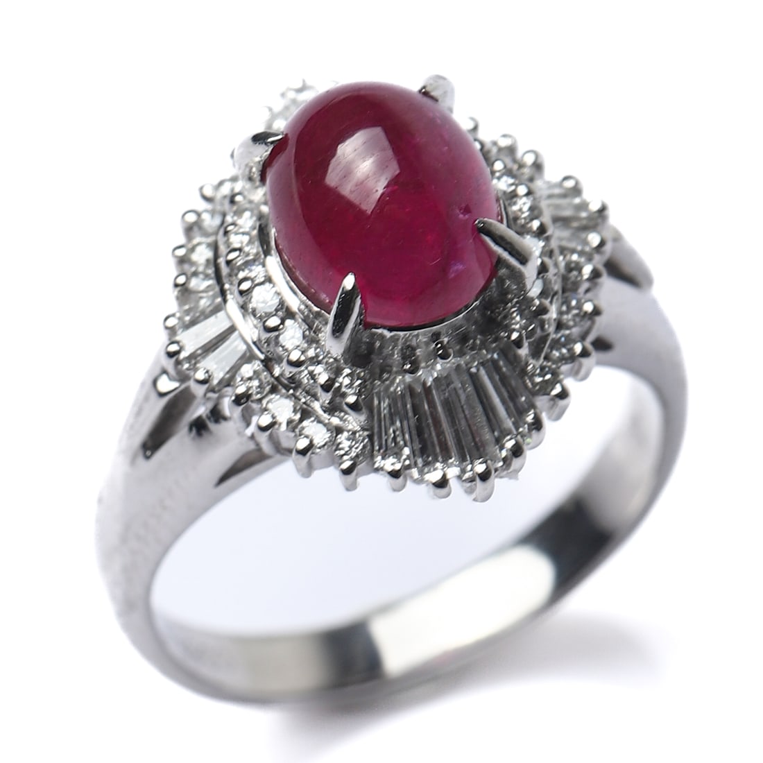 RETRO PERIOD PLATINUM RUBY AND DIAMOND RING: Dimensions Inner diameter: 21/32 in (16.5 mm); Weight: 7.4 g Description This striking Retro-period ring is crafted in platinum and centers on an oval cabochon ruby weighing approximately 2.56