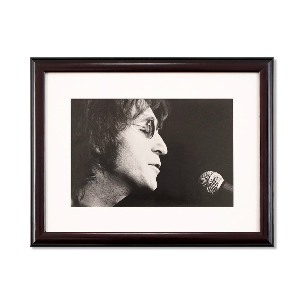 JOHN LENNON SIGNED PHOTOGRAPH: Image Dimensions: 11 7/8 x 8 in (30.3 x 20.3 cm) Framed Dimensions: 17 3/4 x 13 7/8 in (45 x 35.4 cm) Provenance and Authentication: This collectible has undergone a rigorous forensic evaluation.