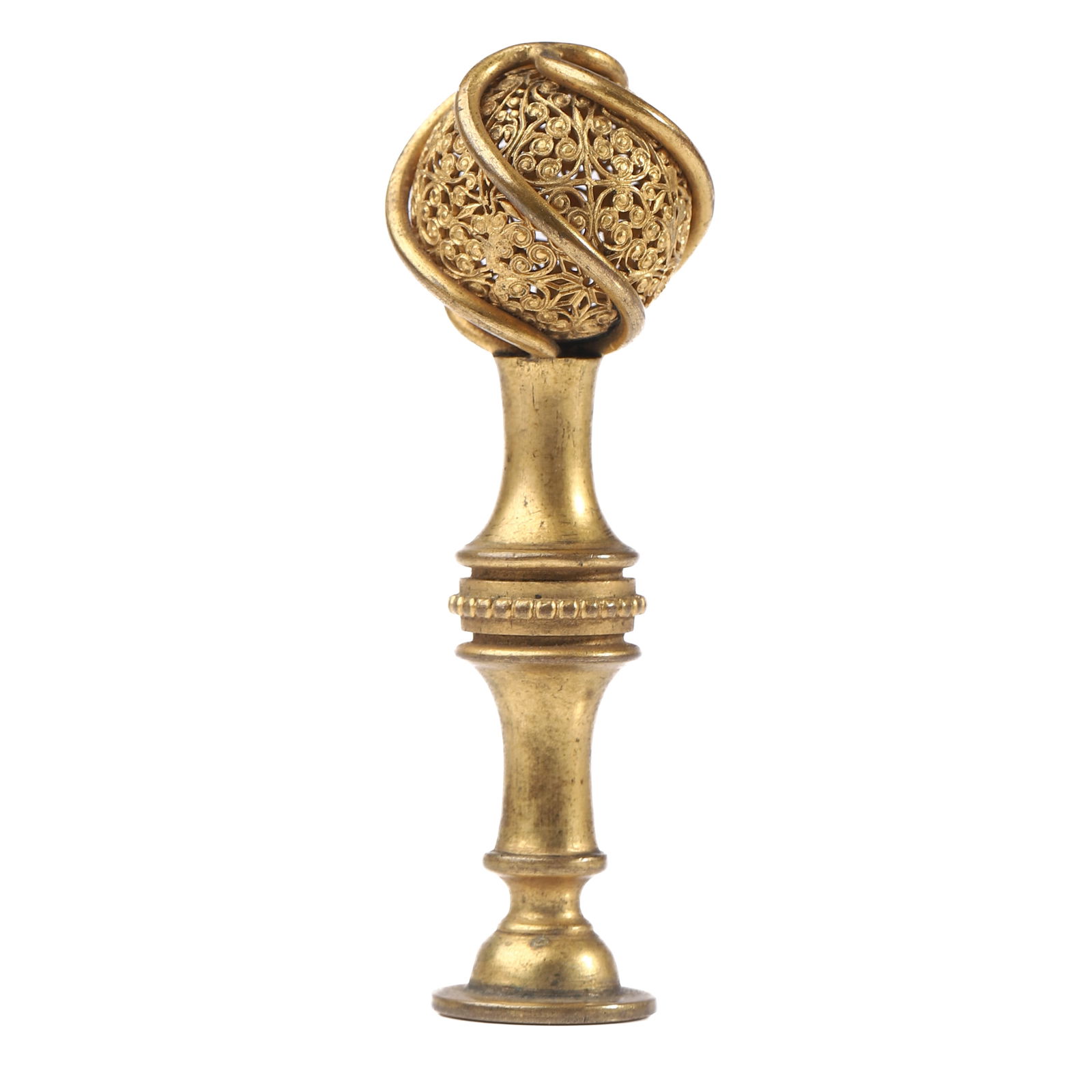 GILT BRONZE FILIGREE SEAL WITH INTERLACED SPHERICAL FINIAL: Dimensions Height: 3 1/4 in (8.2 cm); Weight: 51.1 g Description A finely crafted gilt bronze seal featuring an elaborate openwork filigree sphere encircled by three interlacing bands, forming an