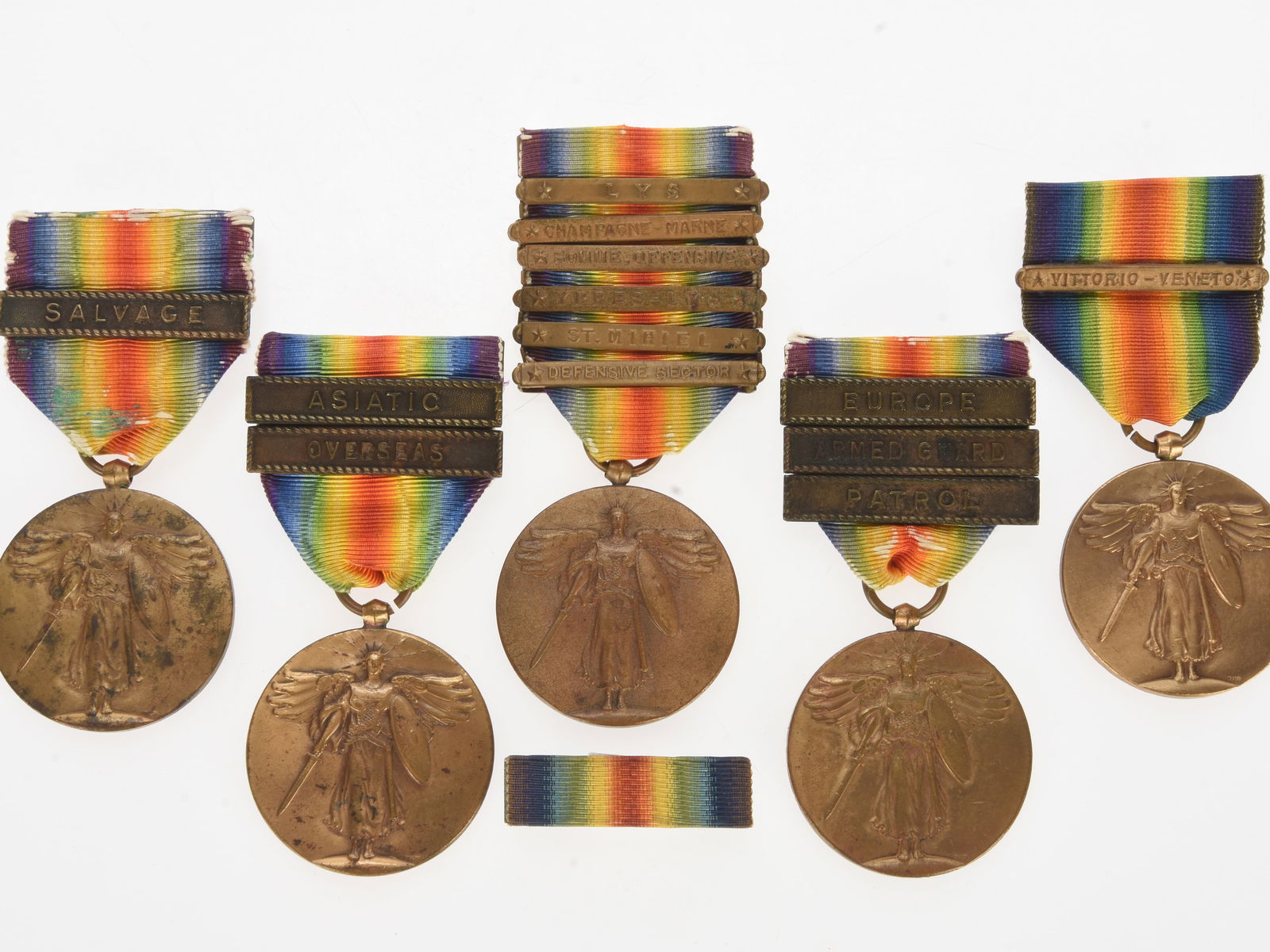 WWI US Victory Medal Collector's Lot: WWI US Victory Medal Collector's Lot Lot of five WWI US Victory Medals. Three feature Navy service clasps, one with Salvage, one with Asiatic and Overseas, and one with Europe, Armed Guard, and Patrol