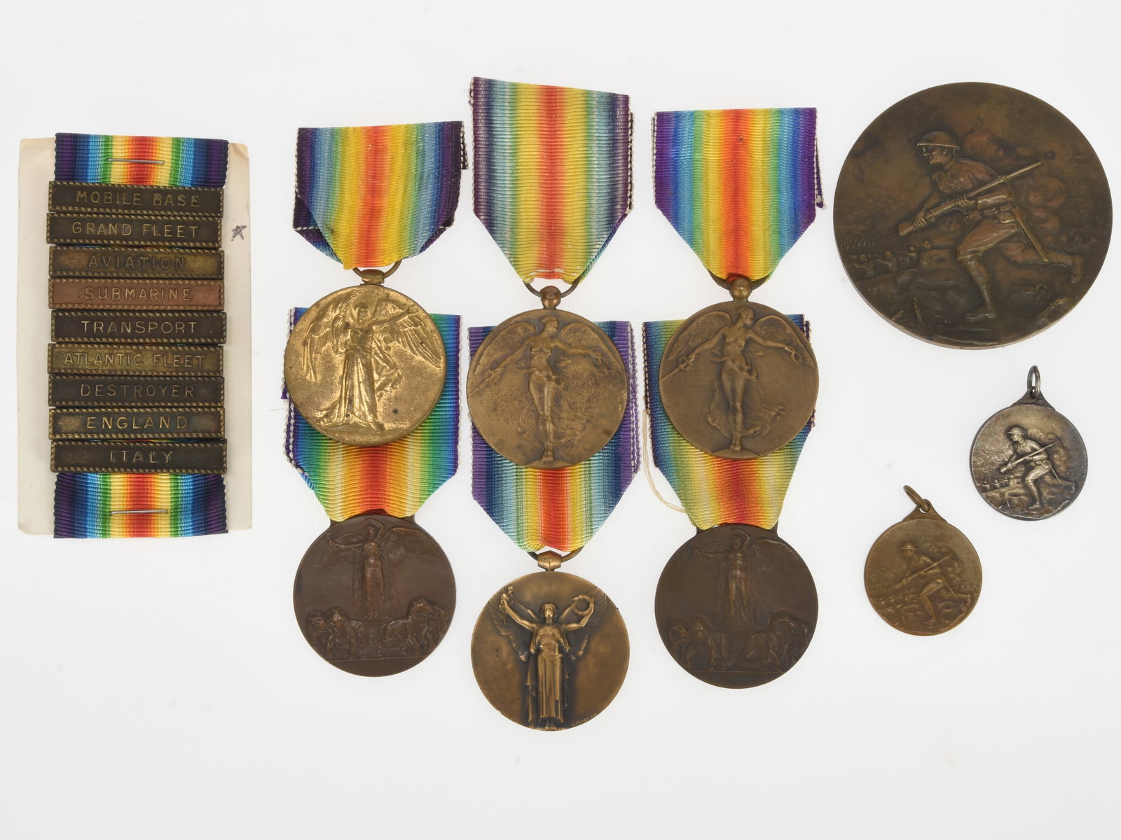 WWI Interallied Victory Medal and "American Doughboy" Table Medal Lot: WWI Interallied Victory Medal & Table Medal Lot: France, Belgium, Italy, Great Britain, & US Navy Service Clasps Includes the following WWI Victory Medals: France, Italy (two examples), Belgium (two e