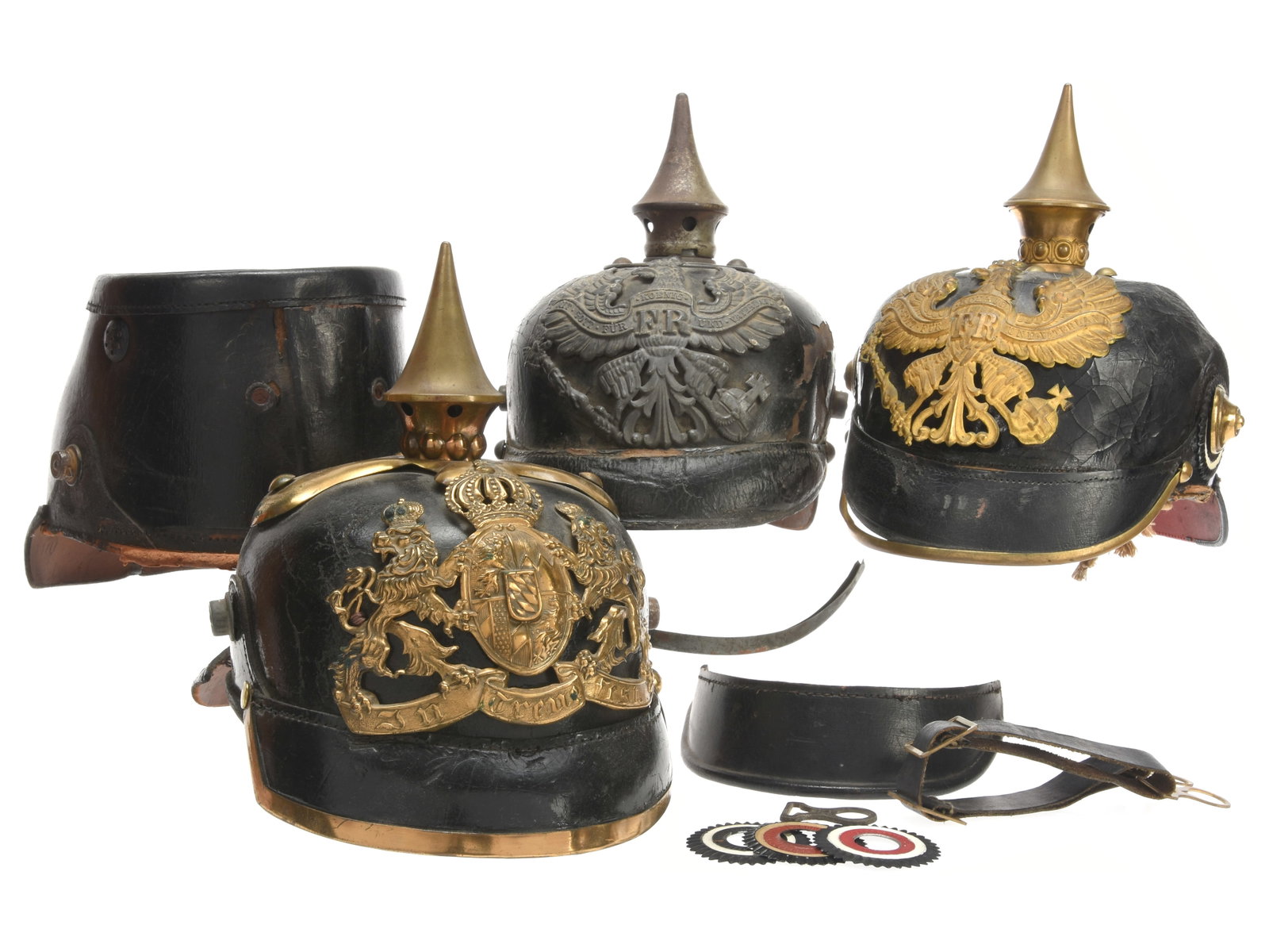 Imperial German Headgear Lot: Three Scratch-and-Dent Pickelhauben & One Derelict Shako: Imperial German Headgear Lot: Three Scratch-and-Dent Pickelhauben & One Derelict Shako A parts / projectlot which includes a repairable brass mounted Bavarian pickelhaub with square front visor, cruci