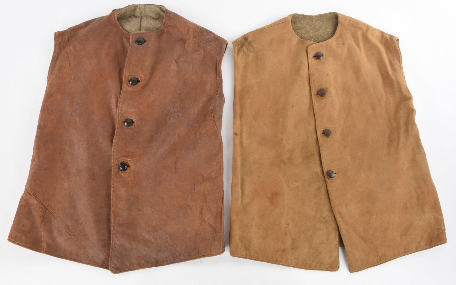British WWI Jerkin Lot: British WWI Jerkin Lot 1915 pattern brown leather jerkin has three plain and one embossed knot leather covered buttons secured by rings on the interior; jerkin is lined in gray blanket wool with a lar
