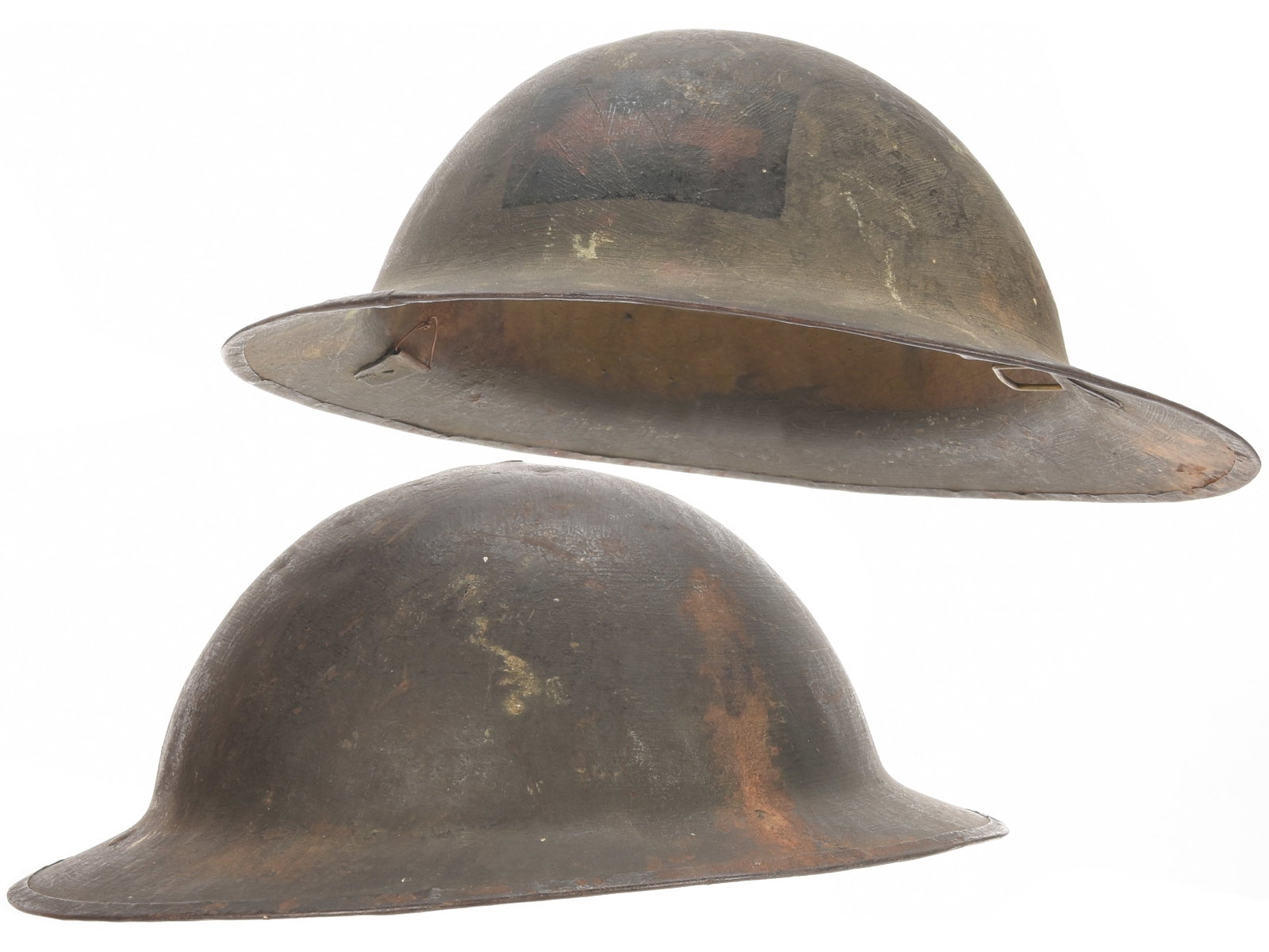 WWI British Helmet Lot with 2nd Canadian Division Machine Gun Bn. Painted Helmet: WWI British Helmet Lot with 2nd Canadian Division Machine Gun Bn. Painted Helmet Two WWI British helmet shells, neither of which retains liner or chinstrap. Both have dark olive exterior finishes. One