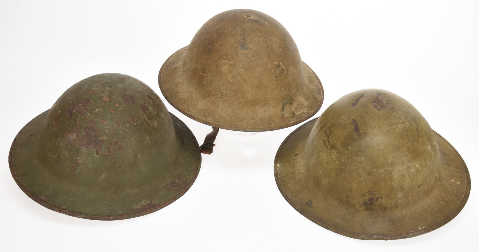 British / Commonwealth WWI Helmet Lot: Three Helmets: British / Commonwealth WWI Helmet Lot: Three Helmets Three WWI British / Commonwealth Helmets: First example has nicekhaki textured finish; interior has third pattern liner with felt crown pad intact 