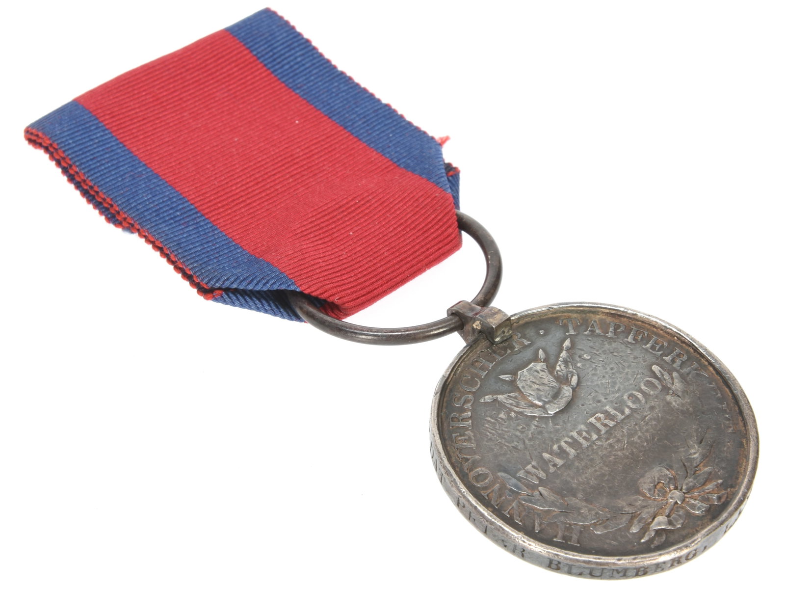 Hanoverian Waterloo Medal: Hanoverian Waterloo Medal. Hanover Waterloo medal. Naming is officially impressed "SOLDAT PETER BLUMBERG, LANDW. BAT. LUENEBURG". Medal presents iron clip (grinding near clip) and replaced suspension 