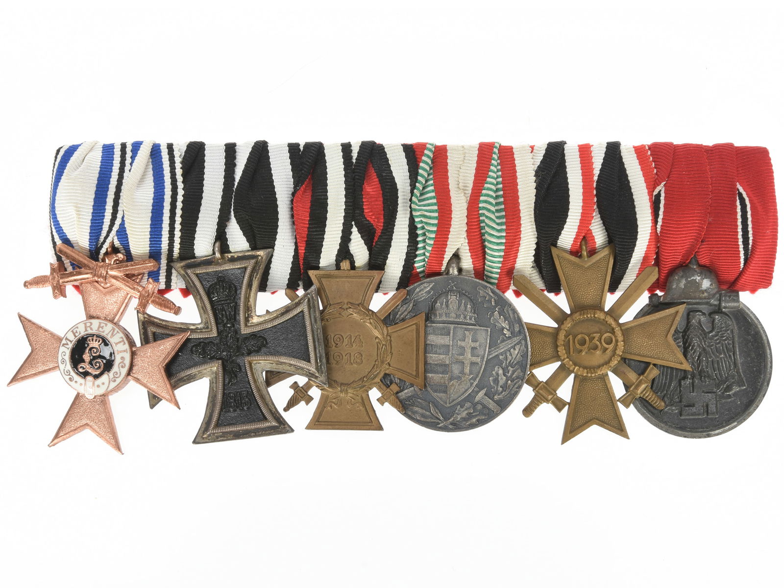 German WWI - WWII period 6-place Medal Bar: German WWI - WWII period 6-place Medal Bar. German World War I and World War II medal bar presenting Bavarian Military Merit Cross 2nd class with swords, 1914 Iron Cross 2nd class, Honour Cross of the