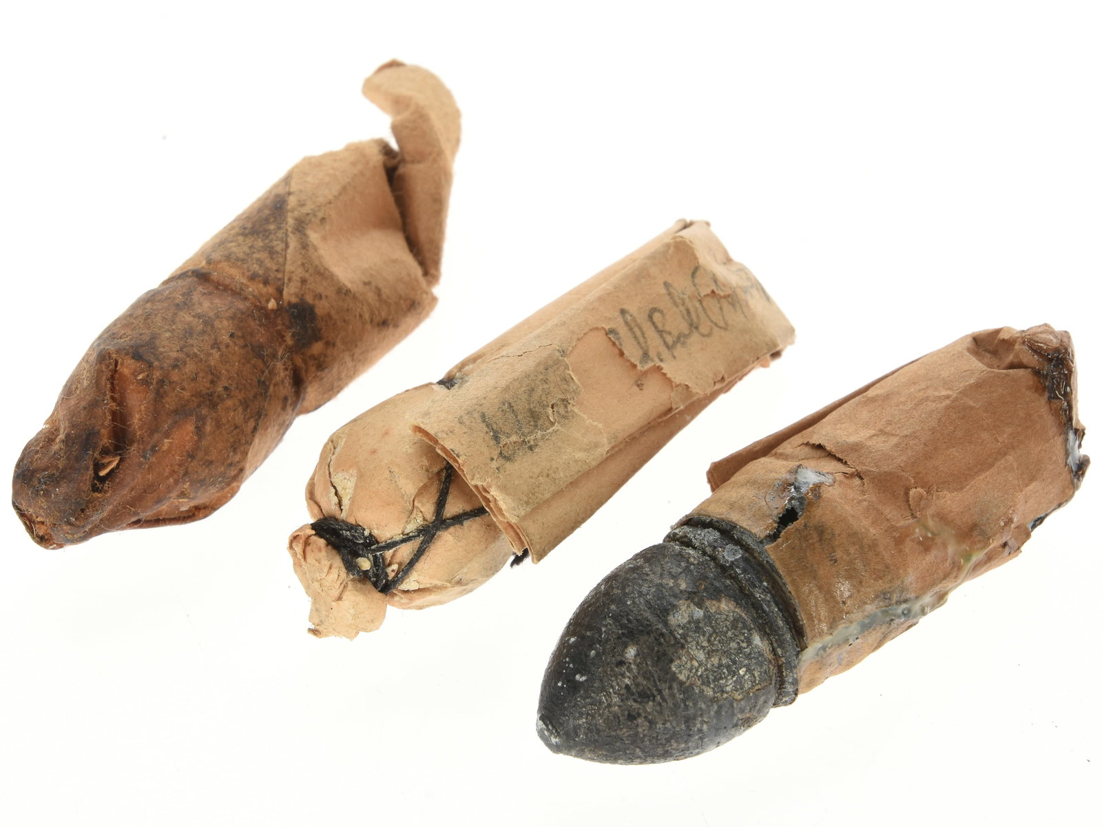 Lot of Three Civil War European Import 'Pumpkin Slinger' Musket Cartridges: Lot of Three Civil War European Import 'Pumpkin Slinger' Musket Cartridges. This lot comprises three Civil War–era paper cartridges of approximately .71 caliber, representing ammunition associated w