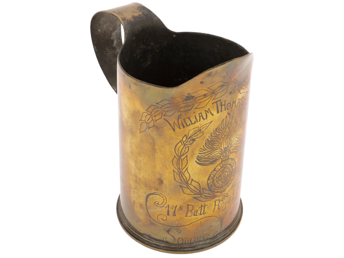 17th Battalion Royal Fusiliers Trench Art Pitcher: Somme, 1916: 11th Battalion Royal Fusiliers Trench Art Pitcher: Somme, 1916. A rather well-made pitcher made from a British 18 Pounder shell casing with integral pouring lip and handle. Engraving reads, "William T