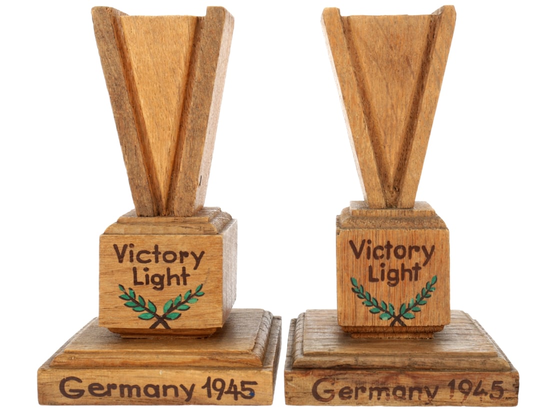 WWII Victory Light Candle Holders: WWII Victory Light Candle Holders Two wooden candle holders stand 14.2cm tall and are not exactly a matched pair, but very close. They each have a bold V-shaped candle stand on a pedestal with the pai