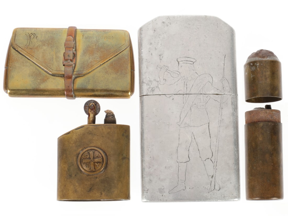 WWI Lighter Lot: WWI Lighter Lot. 1. Aluminum lighter showing a standing soldier with blanket roll and rifle having some food; date 1914. Reverse has Cyrillic writing. 11cm x 5.8cm 2.Commercially made brass lighter
