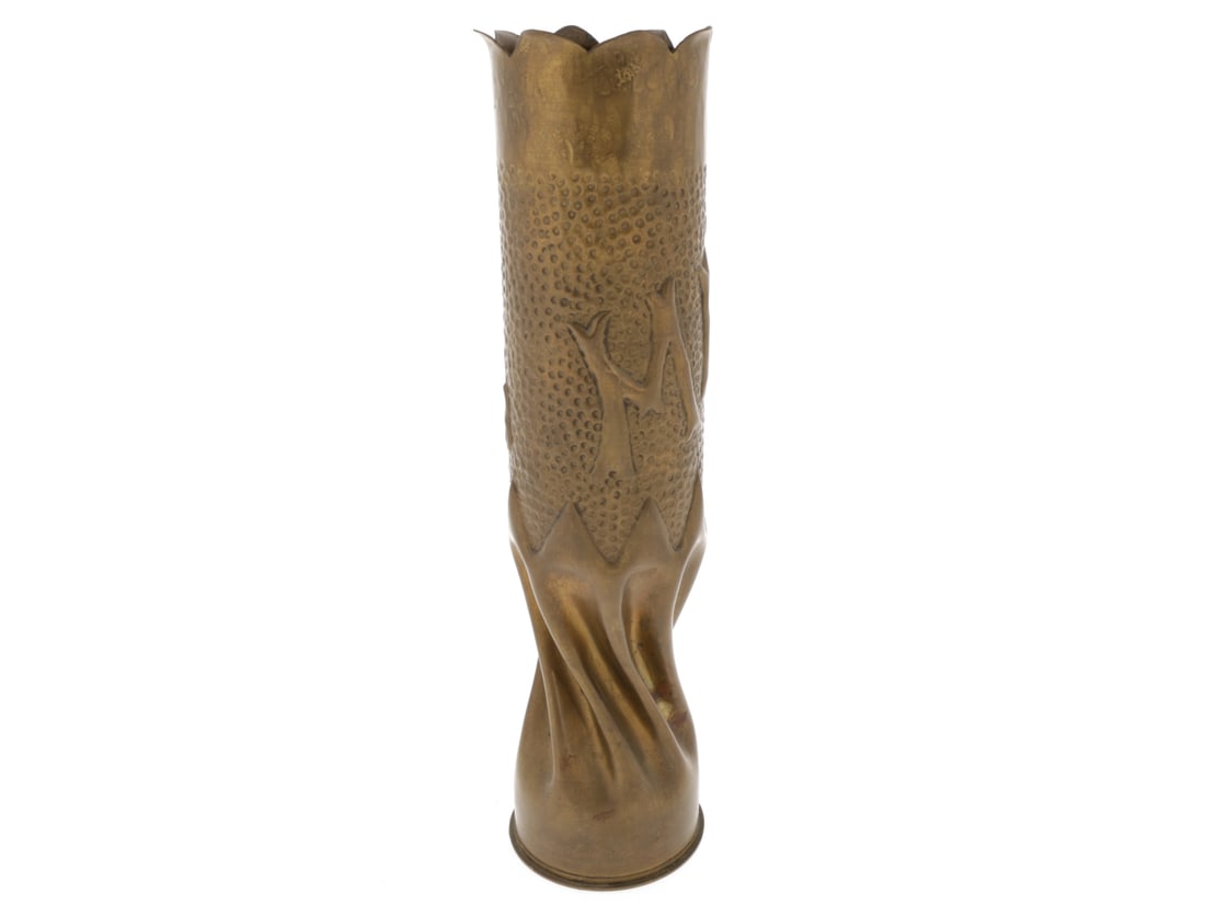 METZ 1918 Trench Art 75mm Shell: METZ 1918 Trench Art 75mm Shell. French 75mm shell casing stands 34cm tall with twisted, fluted base, stylized script "METZ 1918" in repousse against an embossed background, with crenelated top edge. 
