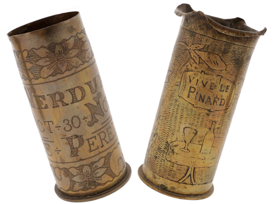 Two 37mm Trench Art Shell Casings: Two 37mm Trench Art Shell Casings One Societe Francaise des Munitions made shell with a rolled scallop rim is engraved with a large flower bloom and a table set with a wine glass and bottle, A wine ca