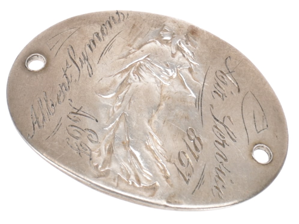 US 650 Aero Squadron Soldiers ID Tag: US 650 Aero Squadron Soldiers ID Tag Curved oblong tag made from a French coin. All traces of the coin except for the faint image of La Semeuse have been removed and coin has been reshaped into a Fren