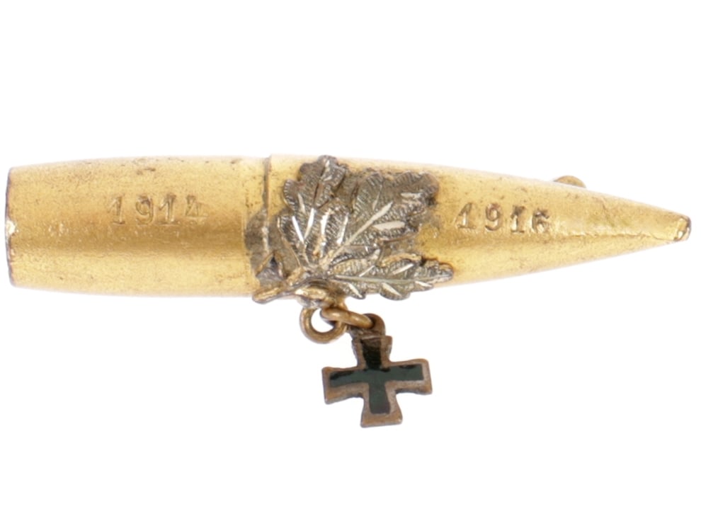 WWI German Themed Bullet Brooch: WWI German Themed Bullet Brooch French 8mm Lebel bullet is stamped on the bottom ATS / D / 3.15 and plated gold. It has a spray of silver oak leaves witha tiny black emaneled Iron Cross charm hanging 