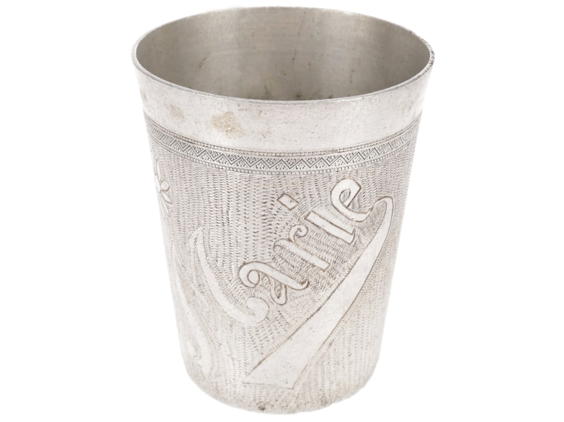 Trench Art Aluminum Cup - Marie: Trench Art Aluminum Cup - Marie 87mm tall aluminum cup has a 51mm base and 69mm rim. It is ebgraved SOUVENIR 1914 1915 1916 on one side and MARIE on the opposite side, all against a zig-zag background