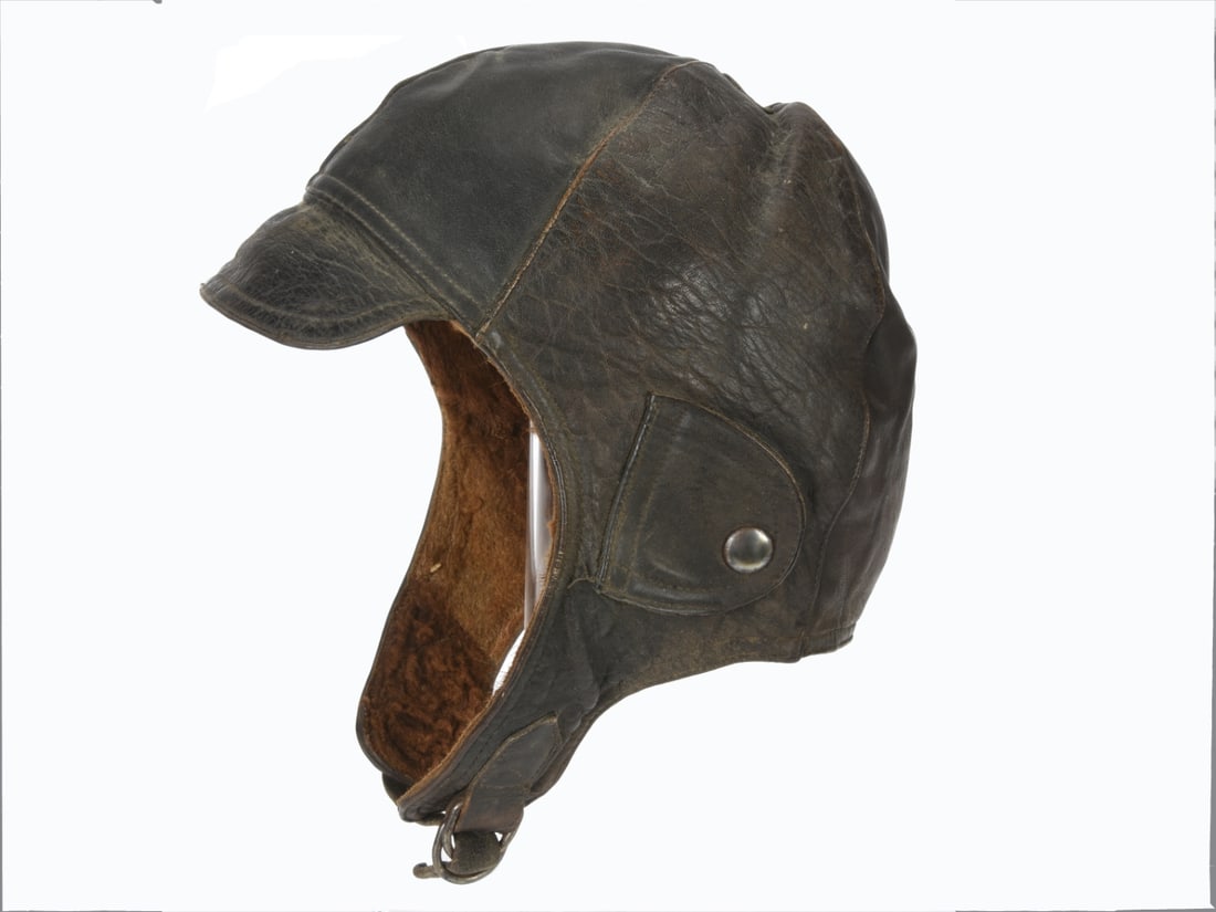 Imperial Aviator's Flight Helmet & Goggle Mask: Black leather six-panel flight helmet has short loop sewn to the crown, and a small fold-down visor on the front, sides have ear port covers with nickel finish glove snap closures, and the black leath