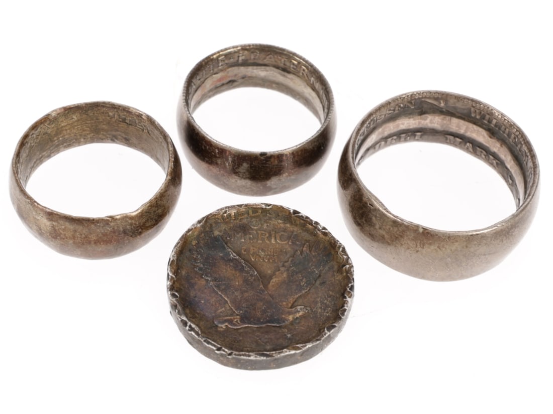 WWI Trench Art Coin Ring Lot: Three complete rings and one ring in progress. 17mm diameter silver ring is 7mm wide, made from a 1919 dated French coin, heavy wear and patina, uncleaned. 17mm diameter silver ring is 6mm wide made f
