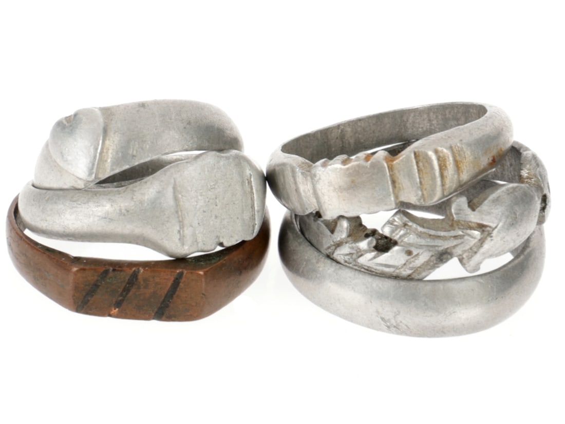 WWI Trench Art Ring Lot: WWI Trench Art Ring Lot Six rings, five aluminum and one copper of varying sizes by different artits. 1) Mostly plain aluminum band measures 5.4mm wide and 19.6mm in diameter. Has a small oval of dots