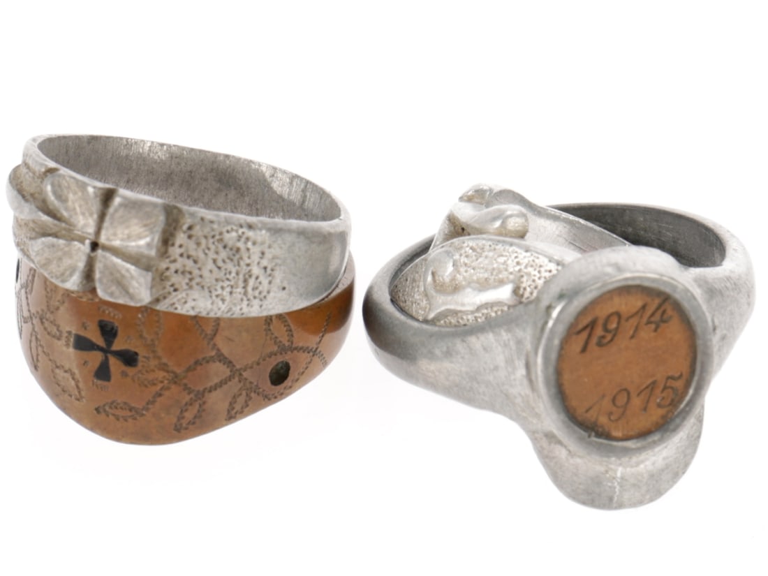 WWI Trench Art Ring Lot: WWI Trench Art Ring Lot Four handmade rings, three aluminum and one copper: 1) Carved aluminum ring with open work bud stems supporting an elongated oval shape with pointed ends. There is a raised ini