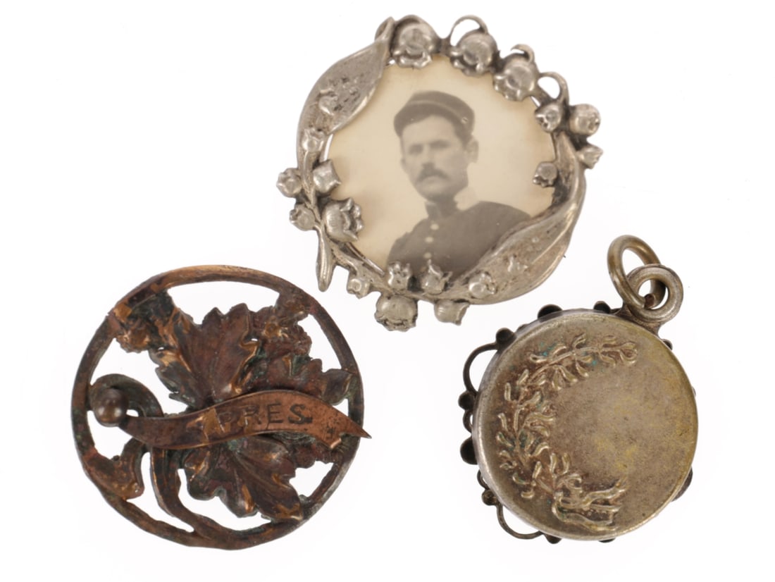 French Sweetheart Pin Lot: French Sweetheart Pin Lot Three commercially made circular brooches: 1) Aluminum frame of Lilly of the Valley blossoms and leaves encircling a photo of a French soldier, reverse shows deep frame to ho