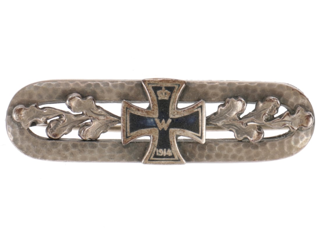 WWI German Sweetheart Brooch: WWI German Sweetheart Brooch A commercial piece, features an enameled Iron Cross dated 1914 flanked by sprays of oak leaves on a narrow hammer-stippled oval. 42mm long, complete with pin clasp.