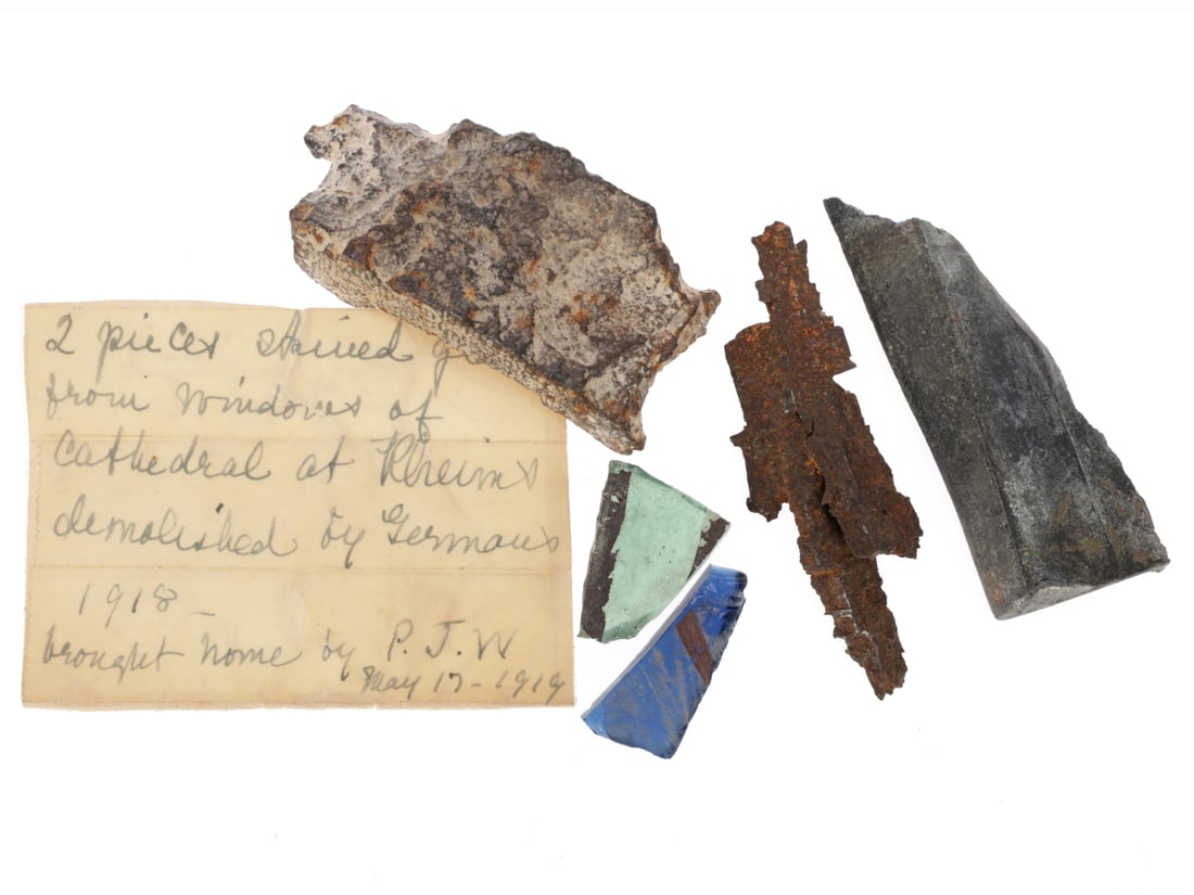 WWI Shrapnel and Rubble Lot: WWI Shrapnel and Rubble Lot Two pieces of iron shrapnel. One looks dug and is a heavy, fairly uniform chunk of an exploded shell measuring 62 x 27 x 15mm. It is slightly curved and one edge has visibl