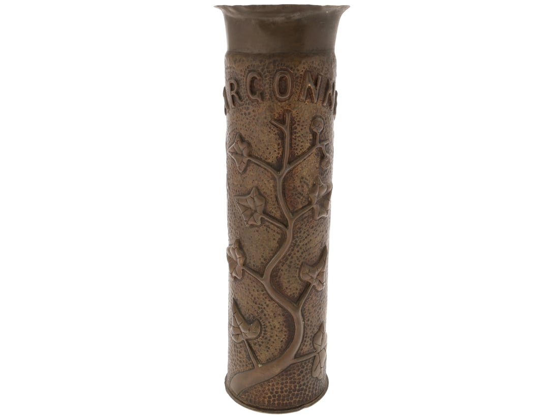 Argonne: Repousse Floral 75mm Trench Art Shell: Repousse Floral 75mm Trench Art Shell: Argonne. French 75mm shell casing stands 29.5cm tall, with a bold floral motif in high relief repousse against an embossed background; "ARGONNE" in an arc across