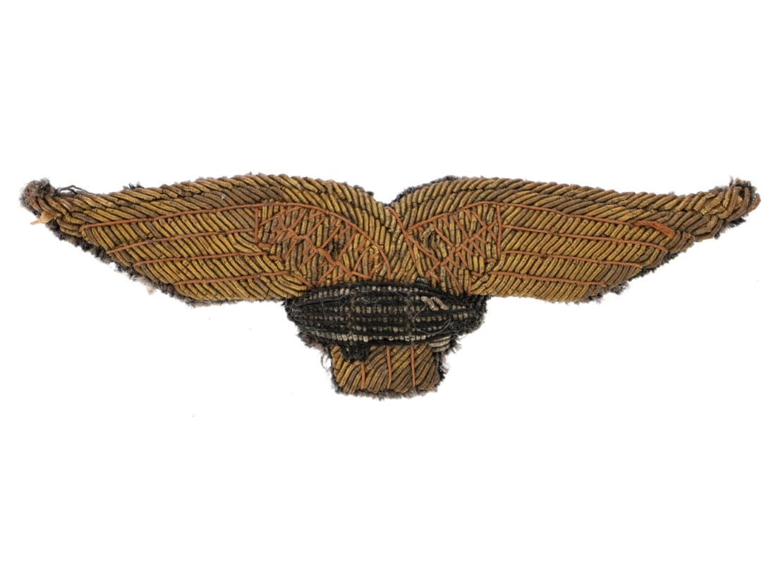 Italian WWI Dirigibili Airship Officer's Cap Insignia: Italian WWI Dirigibili Airship Officer's Cap Insignia. 11cm x 3.5cm bullion insignia features the Italian eagle with a dirigible in the center, on green-gray wool with an unreinforced back. The Italia