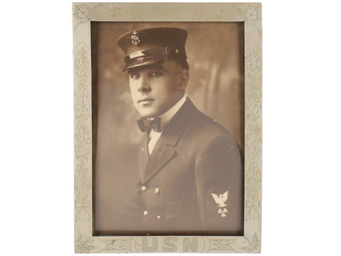 WWI Trench Art Navy Picture Frame: WWI Trench Art Navy Picture Frame 16.5 x 21.5 picture frame made of mitered pieces of aluminum over a wooden frame. The metal is engraved with twining olive branches on the sides. The upper corners ar