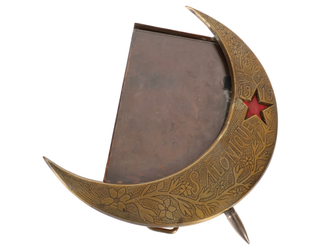 Salonique 1919 Brass Frame with Moon and Red Star: Salonique 1919 Brass Frame with Moon and Red Star. 15.7cmx 18.2cm overall. Vines with leaves and flowers cover the moon and surround the date, star, and "SALONIQUE." A silver colored bullet at the bot