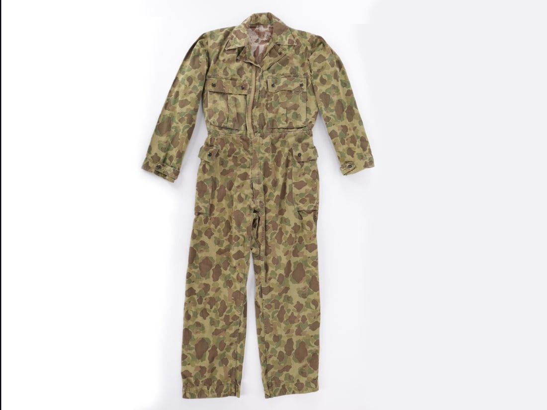 WWII M1942 Jungle Camouflage Coveralls: Named: WWII M1942 Jungle Camouflage Coveralls: Named M1942 one piece jungle suit of camouflage herringbone twill, with zipper front, chest and leg pockets with bronze snaps on flaps, button tabs at cuffs, in