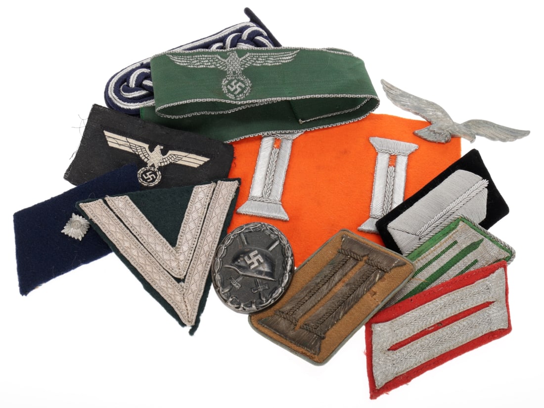 German WWII Insignia Mixed Lot: Collar Tabs & Land Customs Cuff Title: German WWII Insignia Mixed Lot: Collar Tabs & Land Customs Cuff Title. Mixed lot of insignia includes NSDAP, RAD, and Police collar tabs (singles), a black wound badge, 'de-nazified' Luftwaffe cap