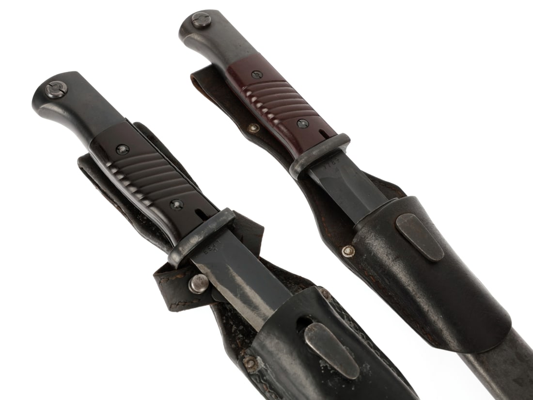 German WWII K98 Bayonets: Lot of Two: German WWII K98 Bayonets: Lot of Two. First example is by Friedrich Herder and has matching numbers. S.84/98 ('K98') bayonet has fullered steel blade which retains 80%+ finish; ricasso has "7789" and 