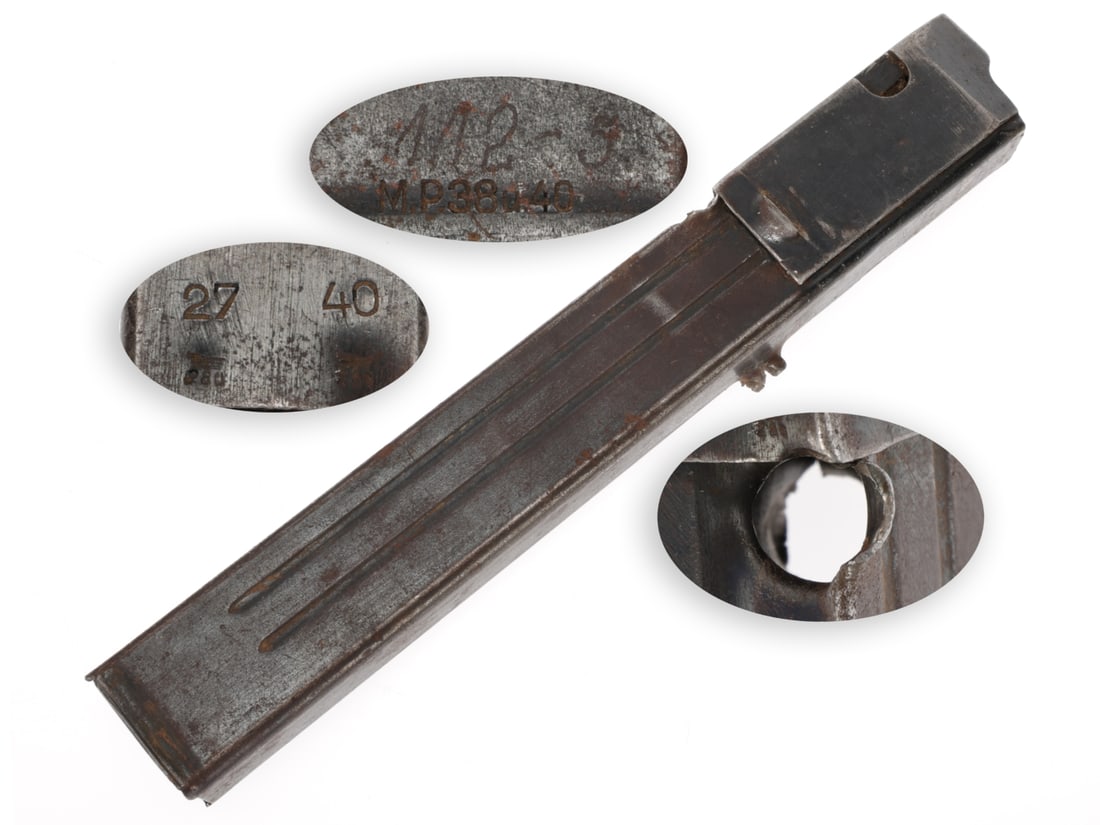 Bullet-Struck German WWII MP-40 Magazine: Bullet-Struck German WWII MP-40 Magazine. MP-40 magazine has an entry hole just below the top collar on the rear side and an exit hole on the opposite corner at a slightly downward angle. Retains the
