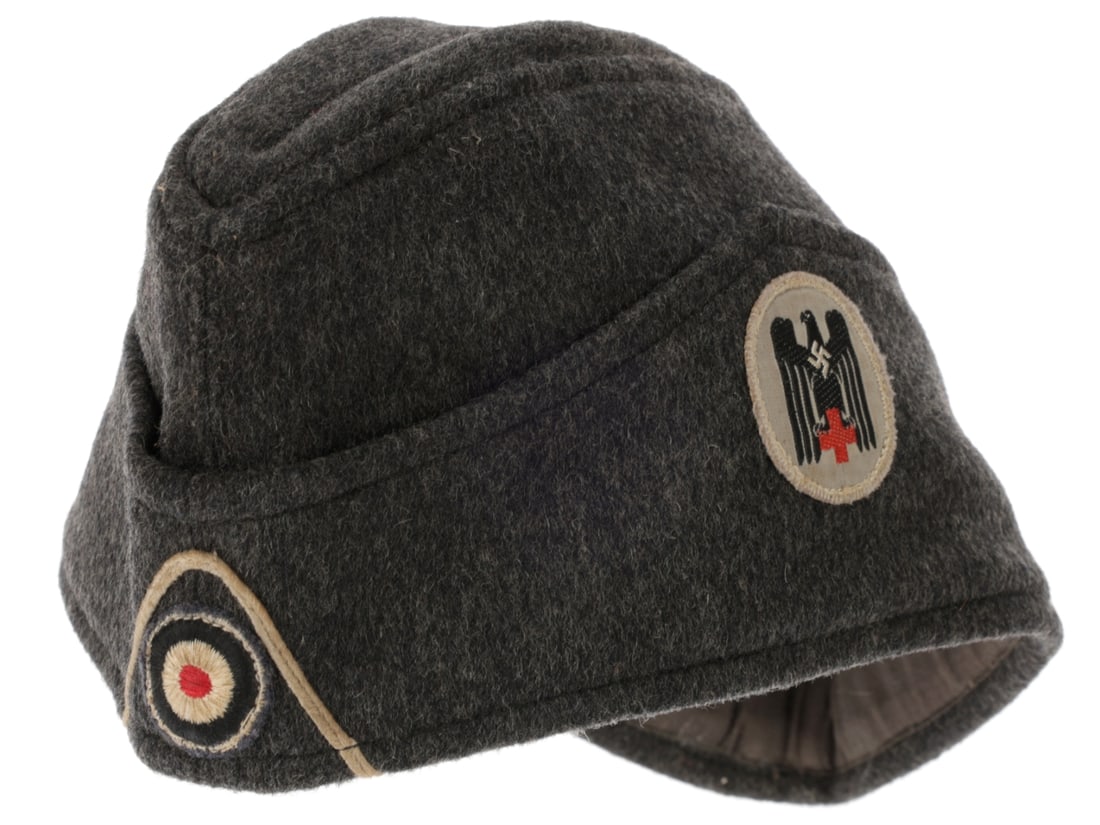 WWII German Red Cross Sidecap: WWII German Red Cross Sidecap. Dark gray sidecap has DRK woven insignia on the left side; obverse with white soutache inverted chevron braid and woven Reichs cockade. Interior has dark gray twill cott