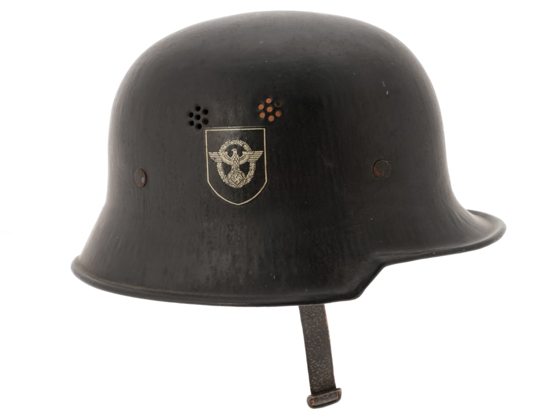 German WWII Fire Police Helmet: German WWII Fire Police Helmet. M34 civic helmet has black painted finish and pairs of punched vents in either side, interestingly with the decals inverted - the police eagle decal is on the left side