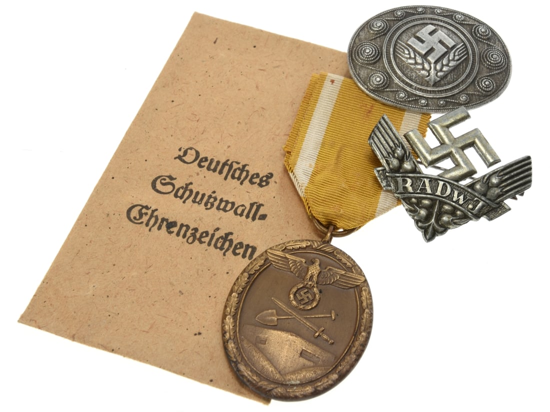 West Wall Medal With Envelope And Two RADwJ Female Labor Service Badges: West Wall Medal With Envelope And Two RADwJ Female Labor Service Badges Group of three German Third Reich awards and insignia relating to the fortification of the western frontier and the Reich Labor 