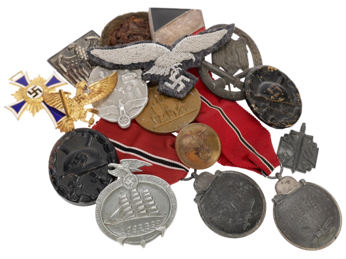 German WWII Medals & Metal Insignia Mixed Lot: German WWII Medals & Metal Insignia Mixed Lot. Features two Eastern Front medals, two black wound badges, a zinc General Assault Badge which is unmarked and has a missing catch, a Luftwaffe office