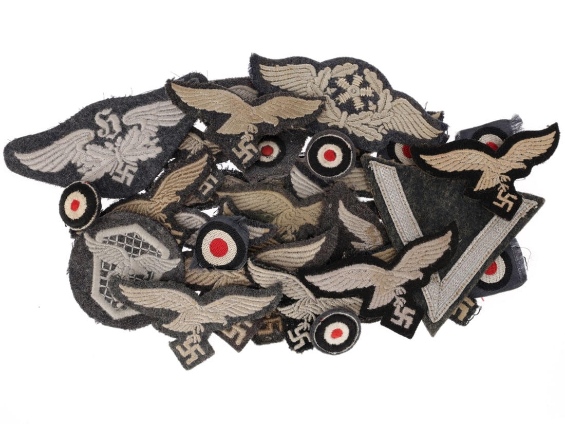 Luftwaffe Breast & Cap Eagle Lot: Luftwaffe Breast & Cap Eagle Lot. Seventeen embroidered on cloth Luftwaffe breast and cap eagles, including two trapezoid insignias for the M43 cap and three cap eagles embroidered on Panzer black