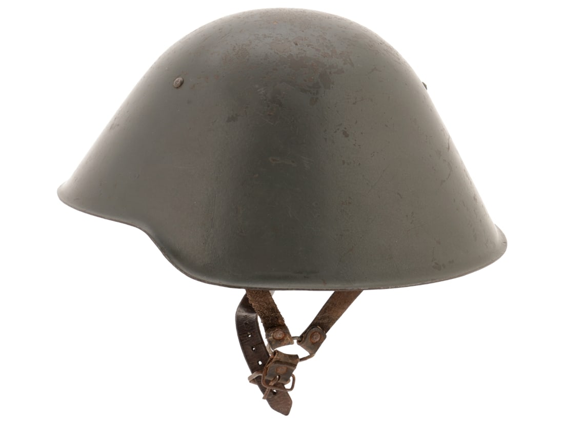 East German M56 Steel Helmet: East German M56 Steel Helmet Early version with the M31 style liner of brown pigskin held in place by three rivets. Exterior shows it was repainted at some point with a darker field gray showing benea