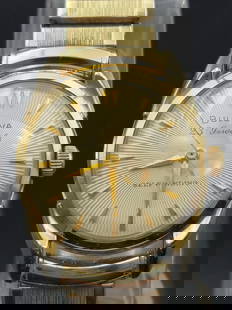 1958 Bulova 23 Jewels self winding Men's Watch 10k RGP Bezel -Stretch Band: This classic 1958 Bulova men's watch features a 23-jewel automatic movement for smooth, reliable performance. The elegant design includes a 10K gold plated bezel and a matching vintage-style stretch