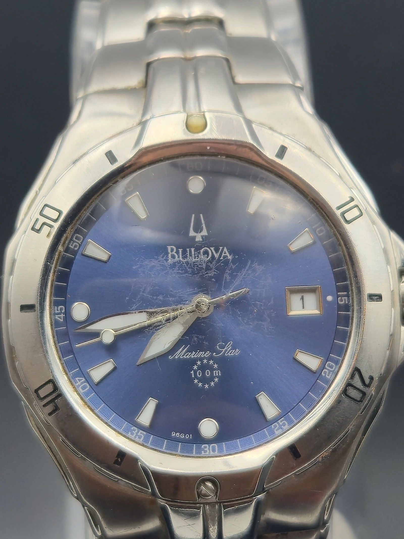 Bulova Marine Star 96G01 – Blue Dial, Stainless Steel, 100m WR: This Bulova Marine Star 96G01 features a bold blue sunburst dial with silver-tone hour markers and luminous hands, housed in a solid stainless steel case with a rotating bezel. It’s water-resistant