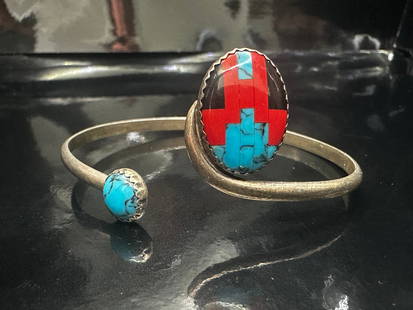 Vintage Sterling Silver Zuni Inlay Cuff Bracelet with Turquoise and Coral: This striking vintage Zuni cuff bracelet features an impressive inlay design with vibrant turquoise and red coral, set in sterling silver. The large central oval showcases meticulous stone inlay work,