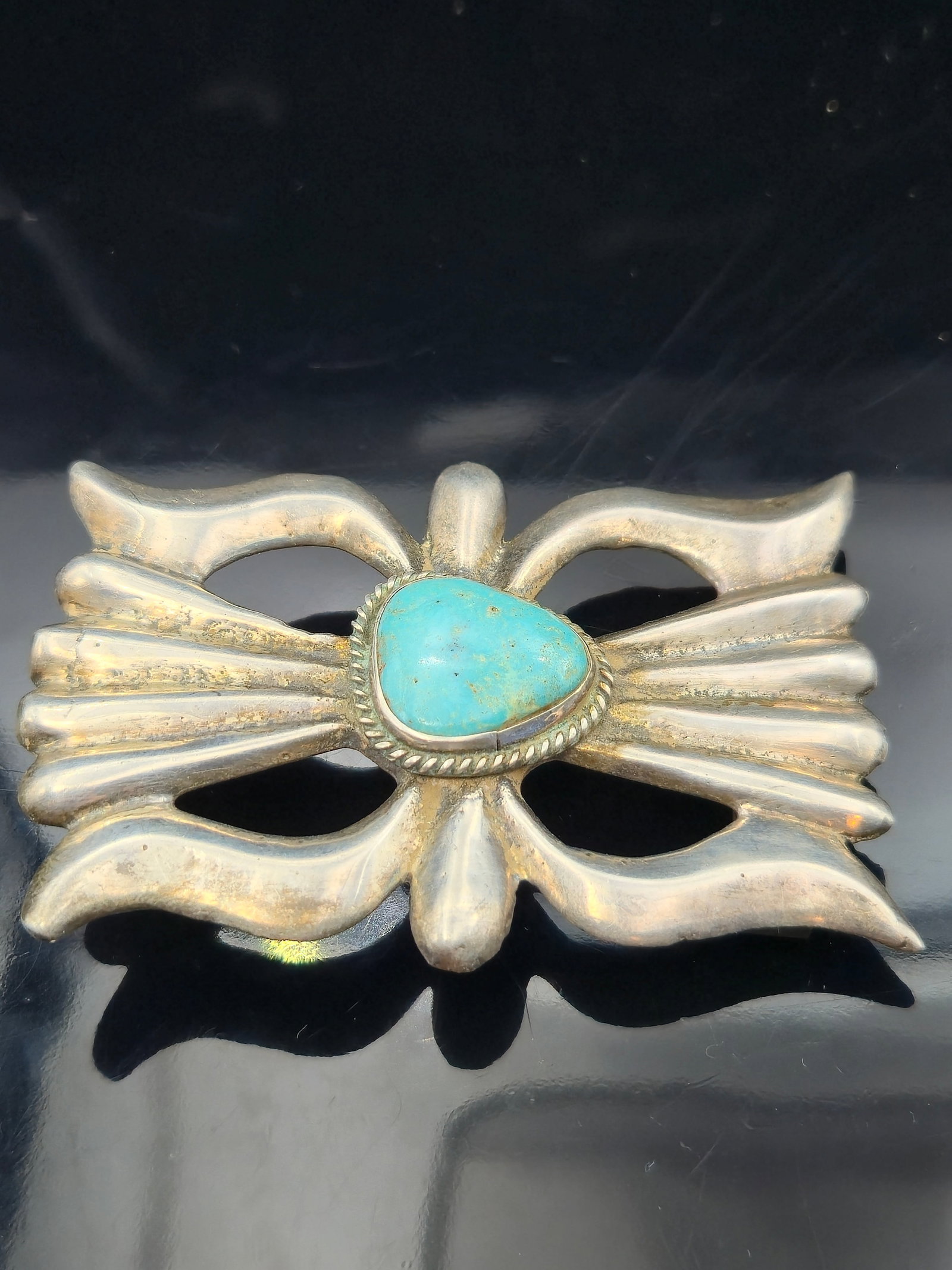 Vintage Navajo Sterling Silver Butterfly-Form Belt Buckle w/ Natural Turquoise – 57.2g – 3.25": This bold vintage Native American belt buckle is handcrafted from sterling silver, featuring a butterfly or bow-shaped repoussé design with flared wings and scalloped accents. At the center is a natu