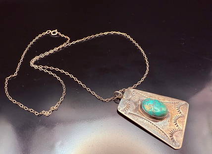 Vintage Navajo Sterling Silver Pendant Necklace with Natural Turquoise stone: A bold and beautifully crafted vintage Javajo Sterling Silver necklace, showcasing a striking oval Turquoise stone set into a hand-stamped silver pendant. the turquoise features a vibrant blue-green m