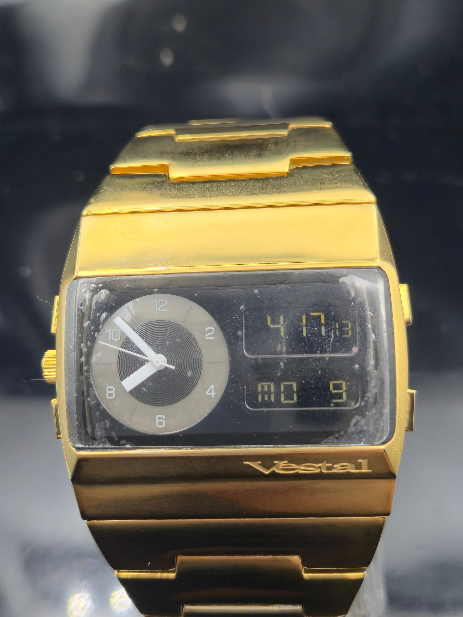 Vestal Monte Carlo MAC003 Gold-Tone Stainless Steel Dual Display Watch – 47mm: Bold and futuristic, this Vestal Monte Carlo MAC003 features a striking gold-tone solid stainless steel case and integrated bracelet. The unique dual display includes an analog dial with baton hands a