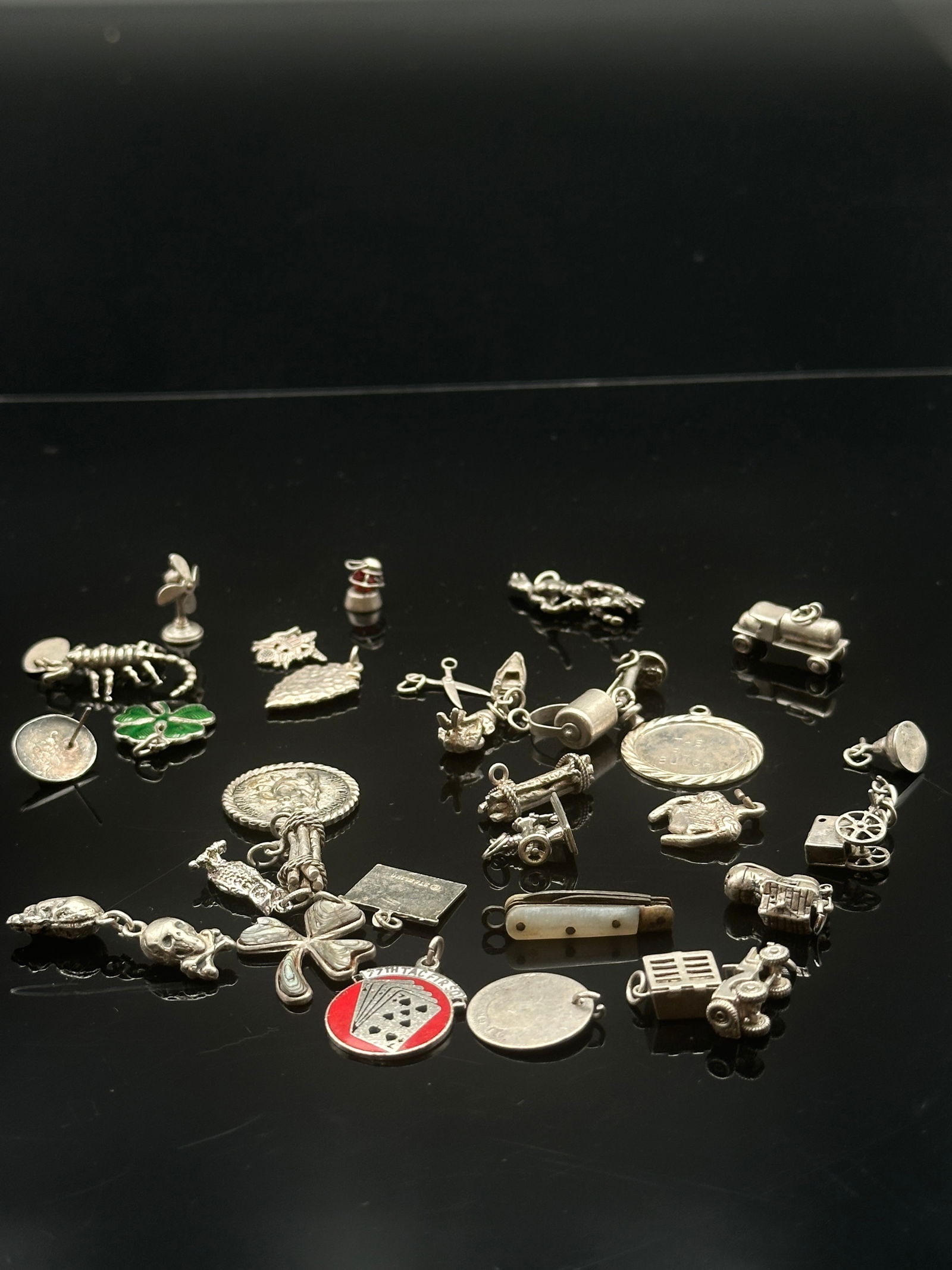 Vintage Sterling Silver pieces for Charm Bracelet Together With Sterling Silver Jewelry: 32 charms marked sterling. Gross weight: 26.71 dwt.