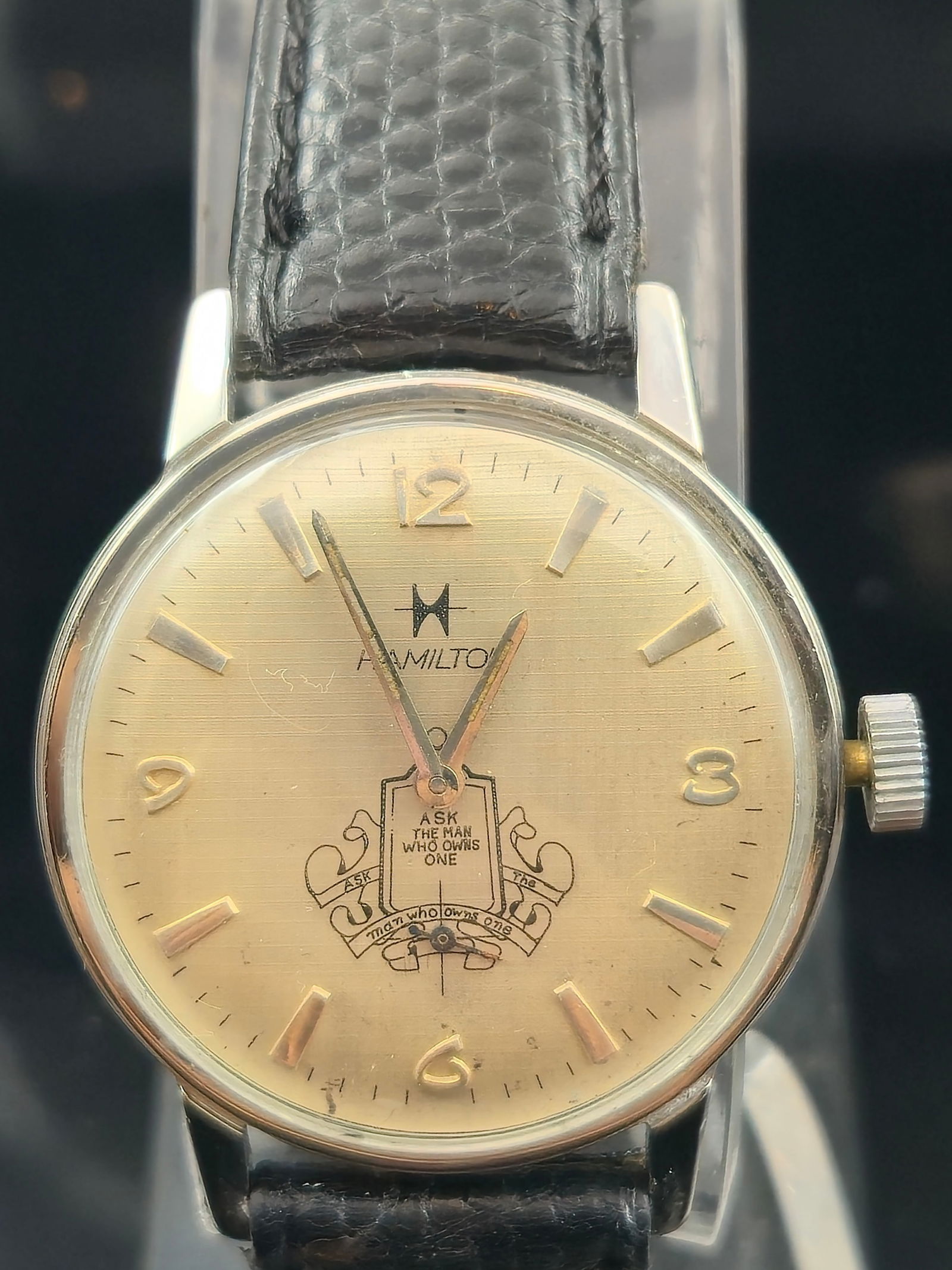 1960s Hamilton 686 Packard “Ask the Man Who Owns One” 17J Watch: Circa 1960s Hamilton men’s wristwatch featuring the Packard Motor Car Company’s iconic “Ask the Man Who Owns One” crest and slogan printed on a gold-tone dial. Dial with applied Arabic num